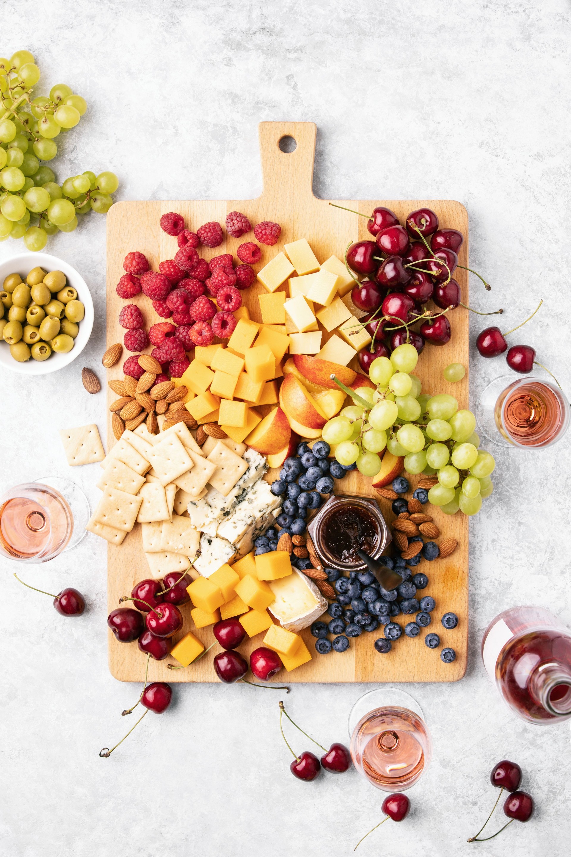 Summer cheese board served with rose wine, view from above